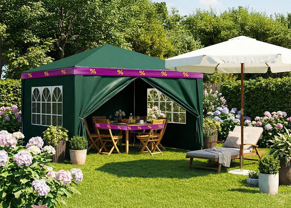 Green party tent with wooden dining set inside, wrapped in purple-yellow discount ribbons, umbrella and sun lounger in front, in a big garden.