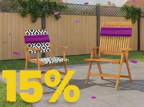 Wooden outdoor garden chairs on a sunny patio with decorative cushions, set against a wooden fence and flowers, featuring a 15% spring promotion banner.