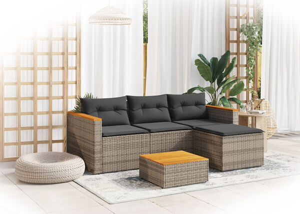 Rattan 3-piece patio sofa set with cushions and coffee table indoors.
