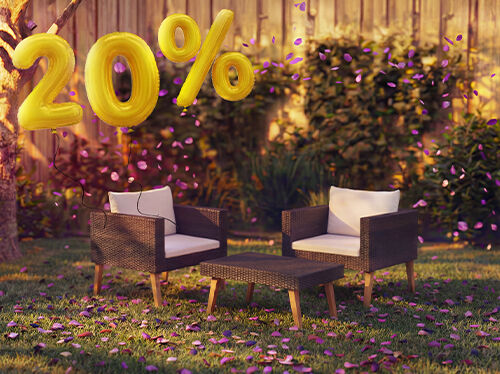 Outdoor rattan lounge chairs with cushions and a small table in a garden setting, decorated with pink confetti and golden 20% discount balloons, highlighting seasonal deals on garden lounge furniture.