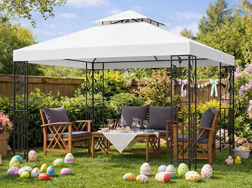 Outdoor garden furniture set under a white gazebo, with wooden chairs and table arranged for Easter gathering, colourful Easter eggs scattered on green lawn, blooming flowers and spring decorations in sunny backyard. 