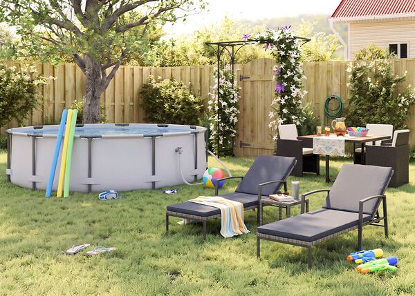 Sunny backyard garden with an above-ground pool, pool noodles, goggles, a beach ball, and flip-flops on the grass. Two black metal sun loungers with grey cushions and a small side table, while an outdoor dining set with dark rattan chairs is arranged near a flowering pergola, wooden fence, garden plants, and summer party accessories.