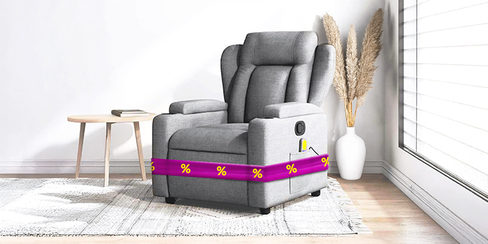 Grey recliner armchair with purple ribbon showing discount icons, coffee table and vase in a styled living room. Click to shop the products in the offer.