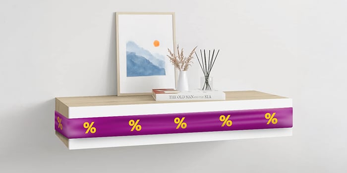 White floating shelf with purple ribbon showing discount icons, with decorations in a styled room. Click to shop the products in the offer.