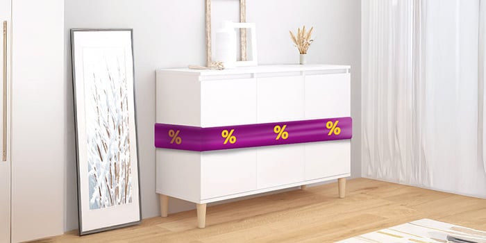 White wooden sideboard with purple ribbon showing discount icons, next to a framed painting, in a styled bedroom. Click to shop the products in the offer.