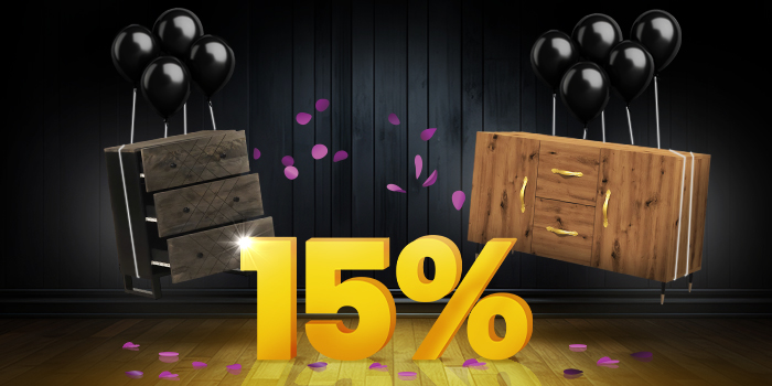 Dark wood chest of drawers and light wood sideboard with black balloons in front of a bright yellow 15% sign on a dark wooden floor.