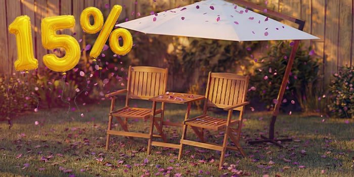 Two wooden outdoor chairs with a small table under a garden umbrella, surrounded by pink confetti and golden 15% discount balloons, highlighting a seasonal sale on umbrellas and sunshades.